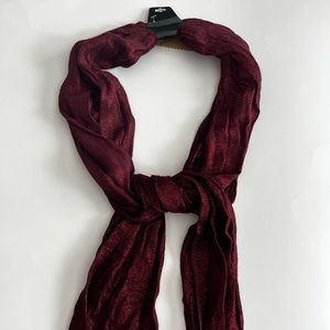 Red scarf with speckles.